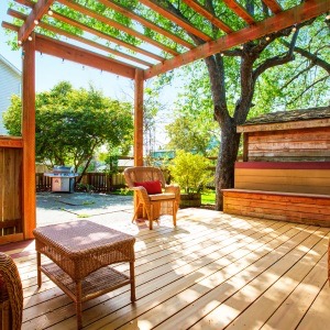 additional blog images  - Backyard deck with wicker furniture and pergola and storage bench